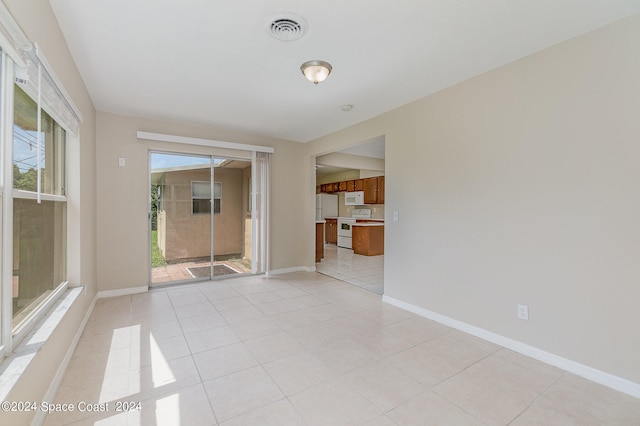 unfurnished room with light tile patterned flooring