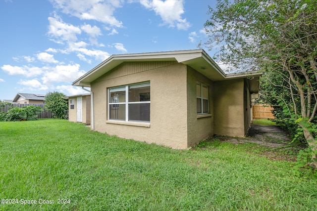 view of side of property with a lawn