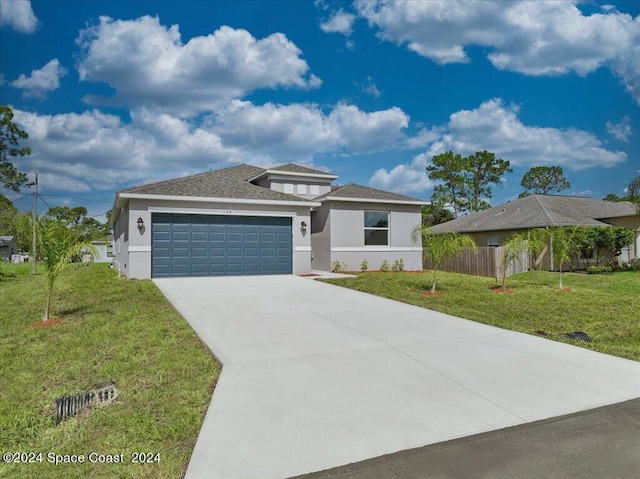 view of front facade featuring a garage and a front lawn