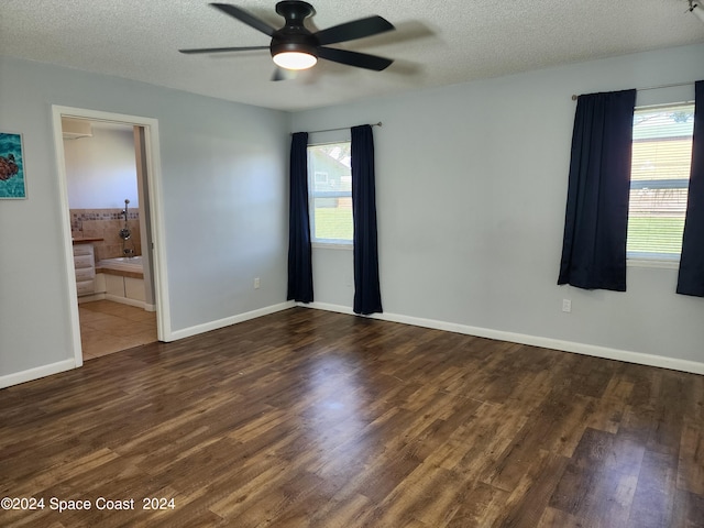 spare room featuring a textured ceiling, dark hardwood / wood-style flooring, and ceiling fan