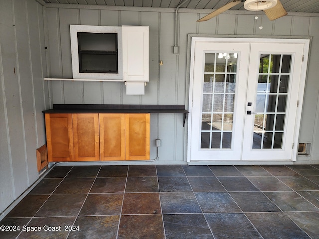 exterior space featuring ceiling fan, wooden walls, french doors, and wooden ceiling