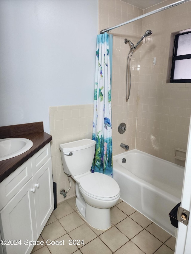 full bathroom with shower / bath combination with curtain, vanity, tile patterned flooring, and toilet