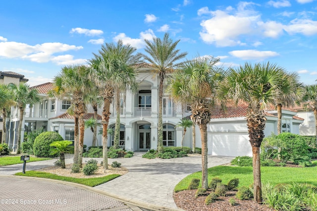 mediterranean / spanish-style home featuring a balcony and a garage