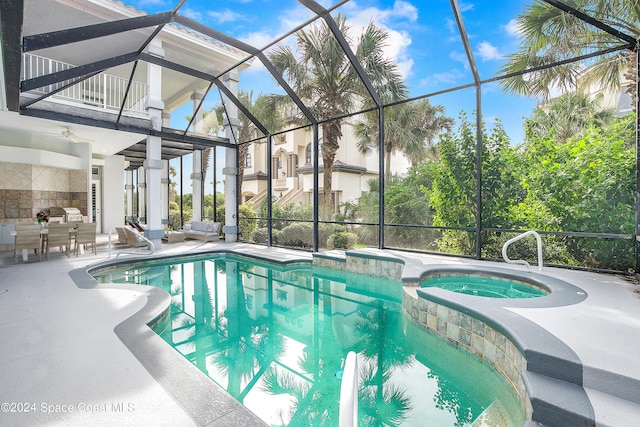 view of pool featuring an in ground hot tub, a patio, glass enclosure, and ceiling fan