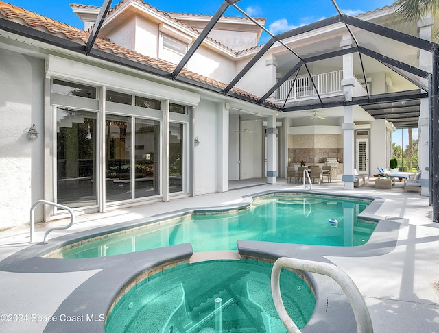 view of pool featuring an in ground hot tub, a patio area, glass enclosure, ceiling fan, and outdoor lounge area