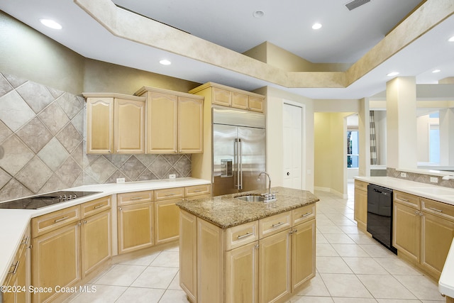 kitchen with light brown cabinets, decorative backsplash, light tile patterned floors, black appliances, and sink