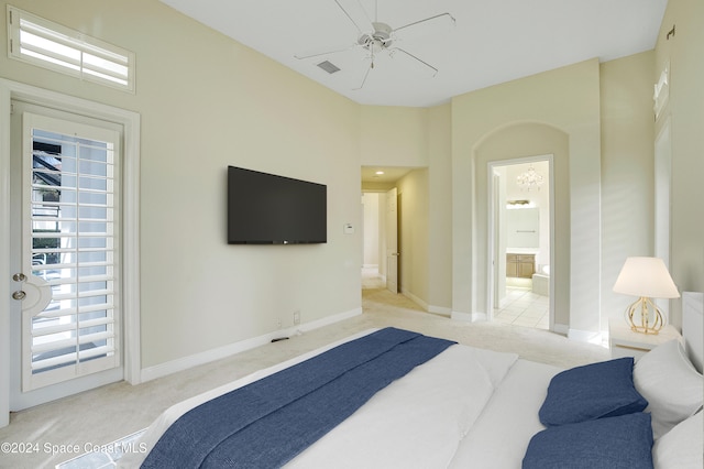 bedroom with light carpet, ensuite bath, and ceiling fan