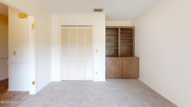 unfurnished bedroom featuring a closet and carpet