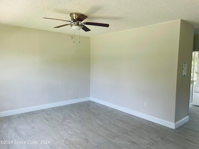 spare room with ceiling fan and a textured ceiling