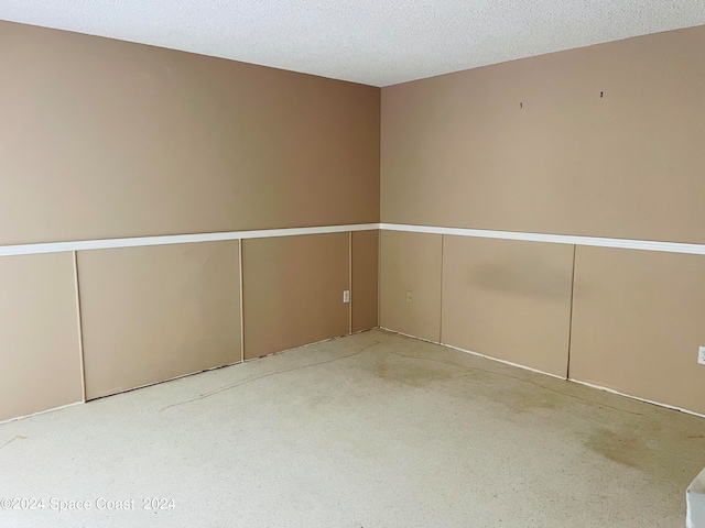 unfurnished room featuring a textured ceiling