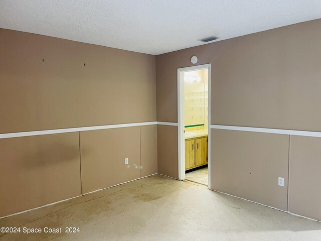 spare room with a textured ceiling