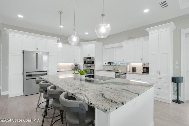 31 Seabridge Dr, Ormond Beach, FL 32176 - kitchen featuring appliances with stainless steel finishes, backsplash, white cabinetry, a spacious island, and recessed lighting