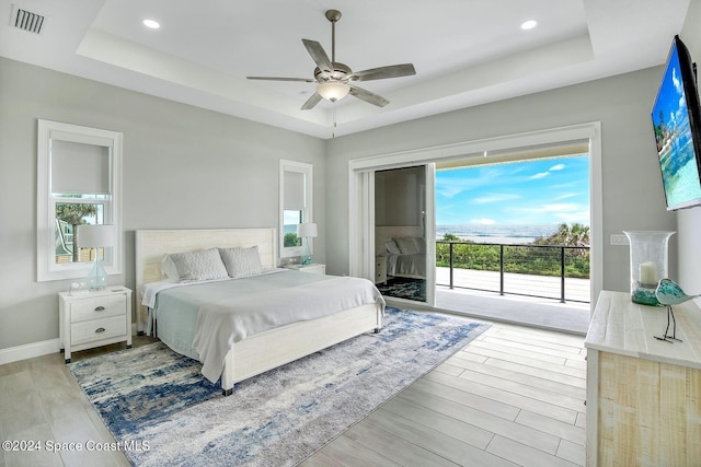 bedroom with light hardwood / wood-style flooring, multiple windows, access to exterior, and ceiling fan