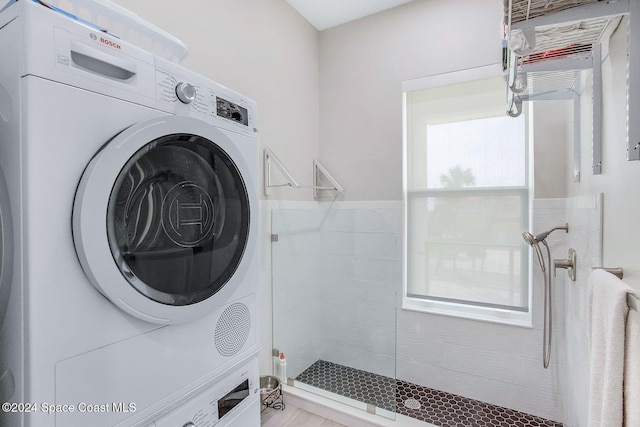 washroom featuring stacked washer and dryer