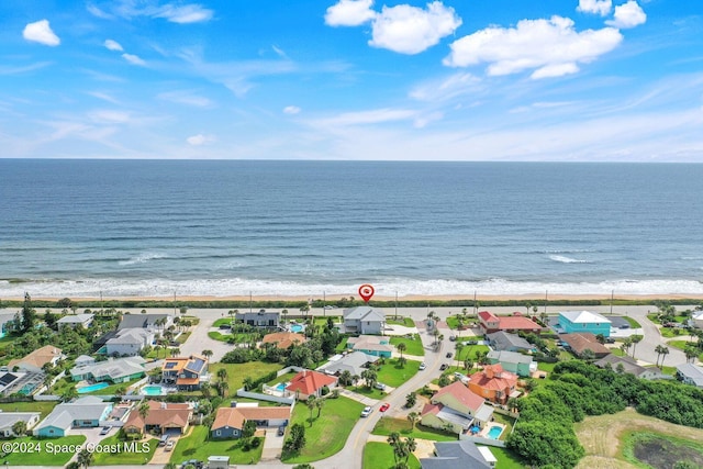 bird's eye view with a water view and a view of the beach