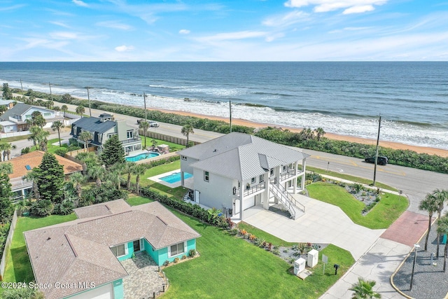 drone / aerial view featuring a water view and a beach view