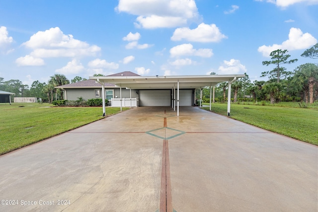 view of front facade with a front yard, a garage, and a carport