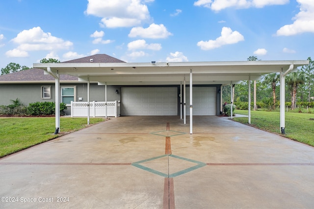 view of front of house with a carport, a garage, and a front yard