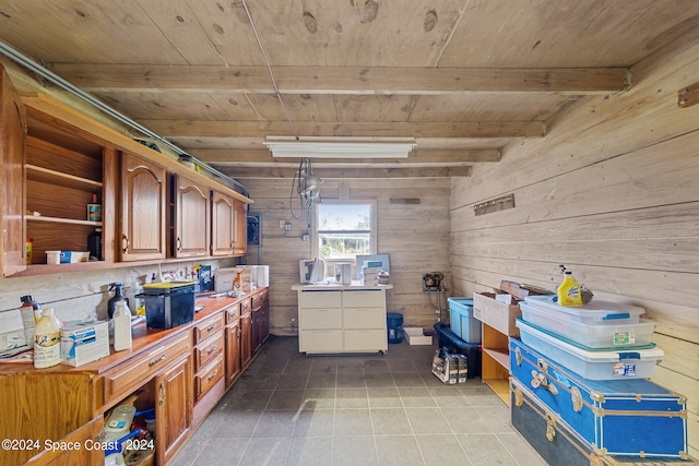 interior space with wood ceiling, wood walls, beamed ceiling, and light tile patterned floors