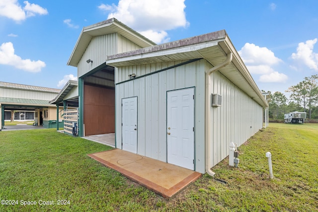 view of outbuilding featuring a yard