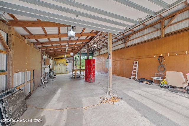 garage with a garage door opener and wood walls