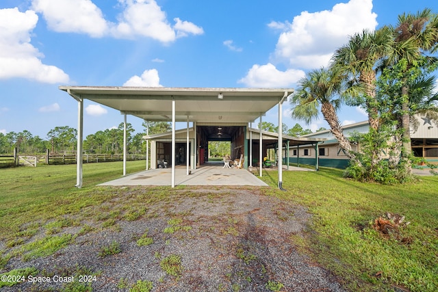 back of house with a yard and a carport