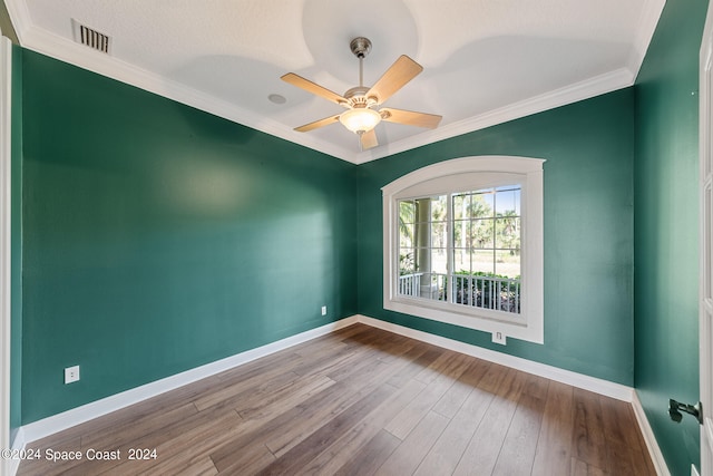 empty room with ceiling fan, hardwood / wood-style flooring, ornamental molding, and a textured ceiling