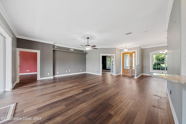 unfurnished living room with ceiling fan with notable chandelier, dark hardwood / wood-style floors, and ornamental molding