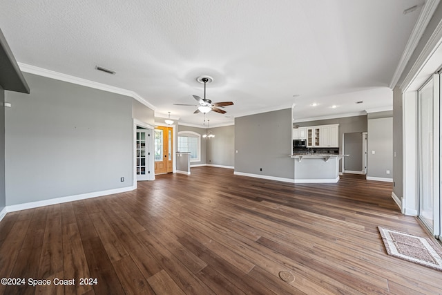 unfurnished living room with a textured ceiling, ornamental molding, dark hardwood / wood-style flooring, and ceiling fan