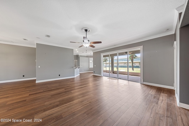 empty room with a textured ceiling, crown molding, hardwood / wood-style floors, and ceiling fan