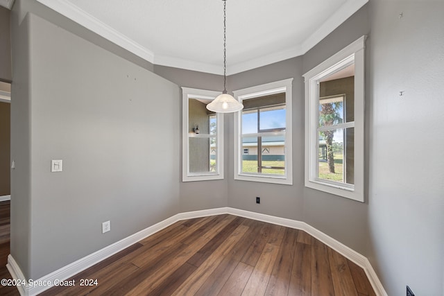 unfurnished dining area with ornamental molding and hardwood / wood-style floors