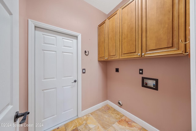 clothes washing area featuring hookup for a washing machine, cabinets, and electric dryer hookup