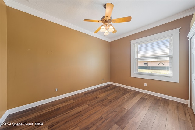 spare room with ceiling fan, ornamental molding, and dark wood-type flooring