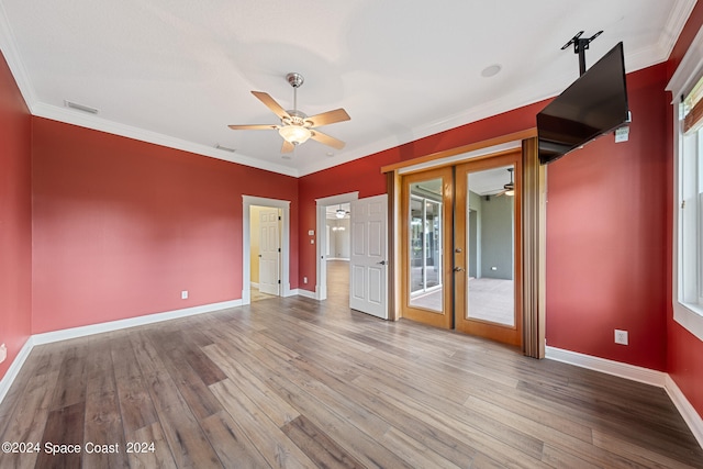 unfurnished room with ornamental molding, ceiling fan, and hardwood / wood-style flooring