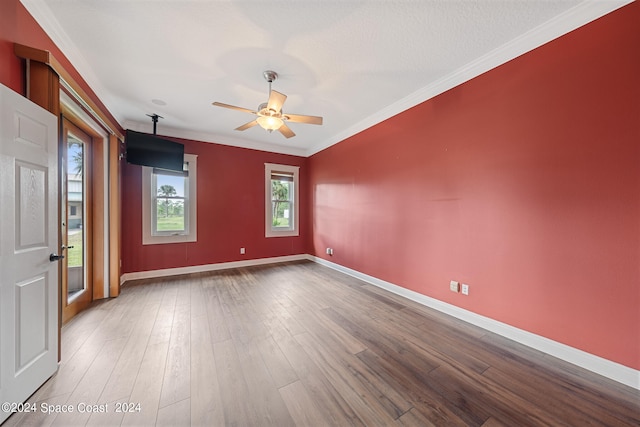 unfurnished room featuring a textured ceiling, ornamental molding, hardwood / wood-style floors, and ceiling fan