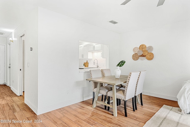 dining area featuring ceiling fan and light wood-type flooring