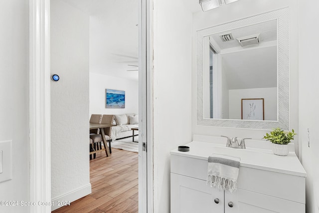 bathroom with vanity and hardwood / wood-style flooring