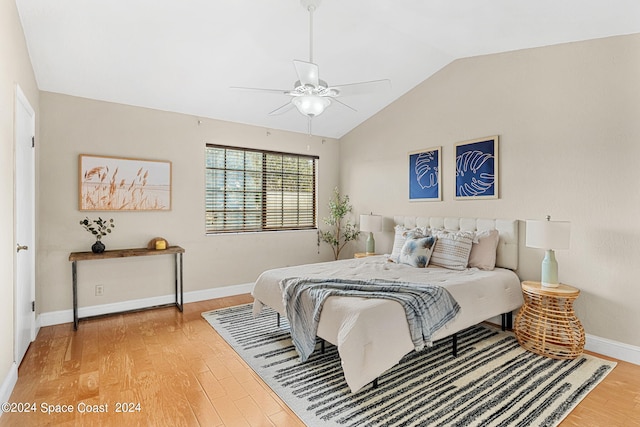 bedroom with vaulted ceiling, hardwood / wood-style floors, and ceiling fan