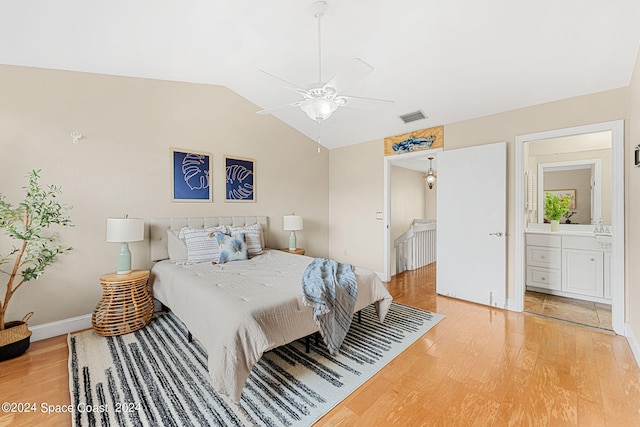 bedroom with wood-type flooring, lofted ceiling, ceiling fan, and ensuite bathroom