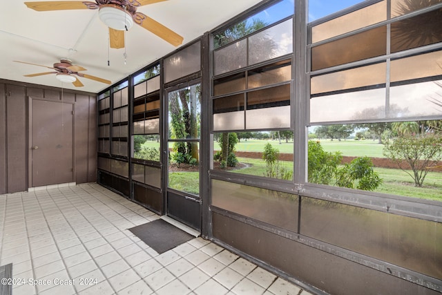 unfurnished sunroom with ceiling fan