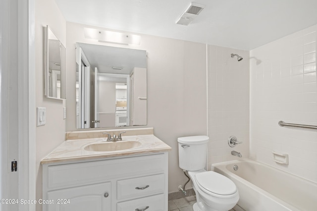 full bathroom with tiled shower / bath, vanity, toilet, and tile patterned floors