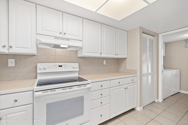 kitchen with white cabinetry, tile counters, electric range, and backsplash