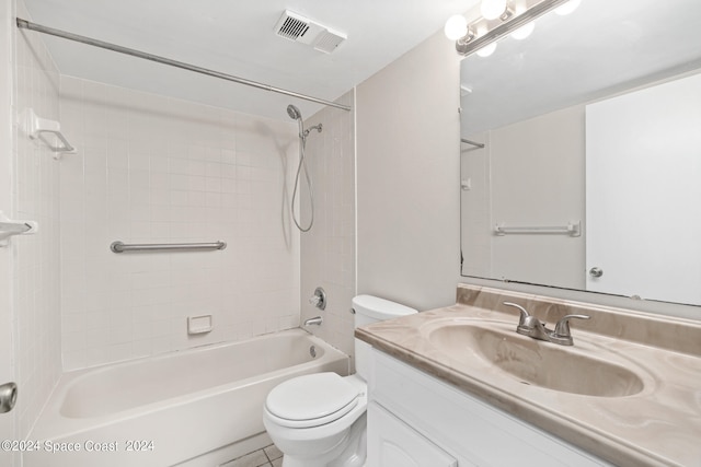 full bathroom featuring vanity, tiled shower / bath combo, toilet, and tile patterned flooring