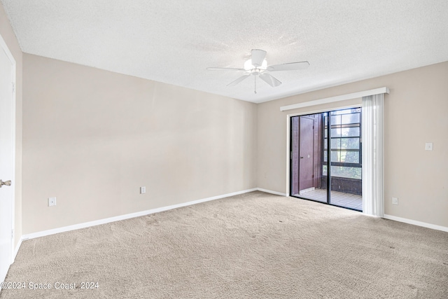 carpeted empty room with ceiling fan and a textured ceiling