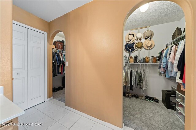 spacious closet featuring light carpet