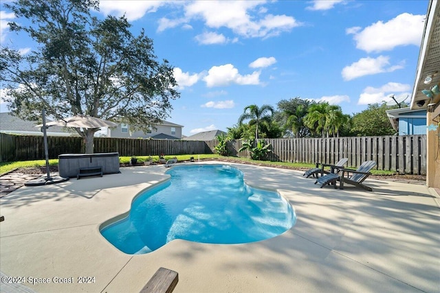 view of pool featuring a patio and a hot tub