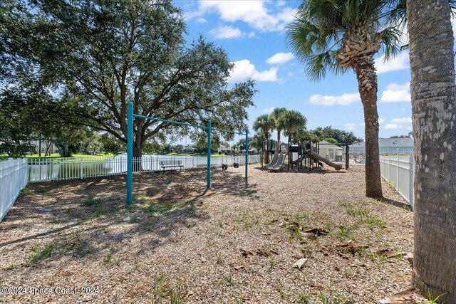 view of yard featuring a playground and a water view