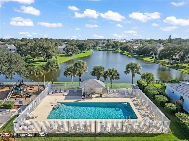 view of pool with a water view and a patio area