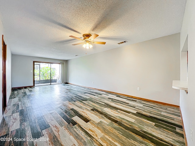 spare room with a textured ceiling, ceiling fan, and hardwood / wood-style flooring