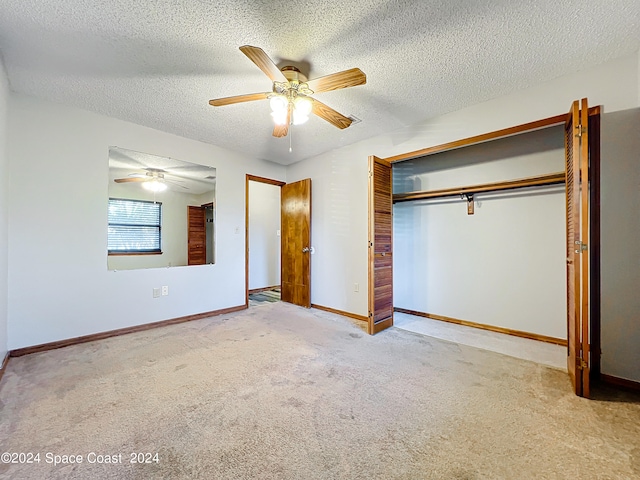 unfurnished bedroom with ceiling fan, carpet flooring, and a textured ceiling